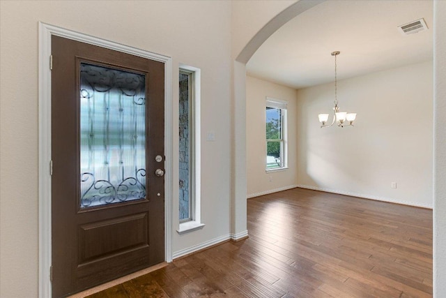 3639 Hermann St, Round Rock, TX 78681 - foyer featuring visible vents, baseboards, a chandelier, arched walkways, and dark wood finished floors