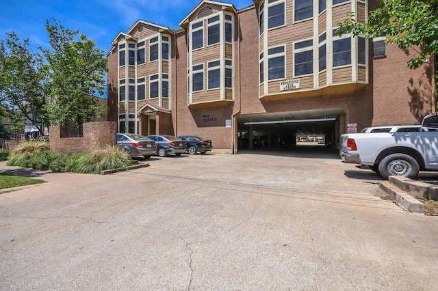 view of building exterior featuring uncovered parking