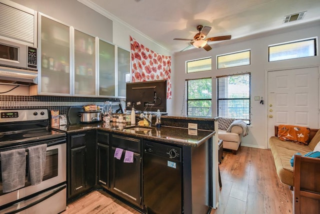 kitchen featuring ceiling fan, a sink, a peninsula, ornamental molding, and stainless steel appliances