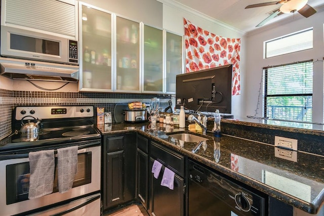 kitchen featuring stainless steel range with electric cooktop, a sink, black dishwasher, white microwave, and ornamental molding