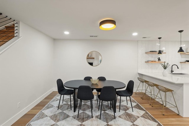 dining room featuring visible vents, recessed lighting, baseboards, and wood finished floors