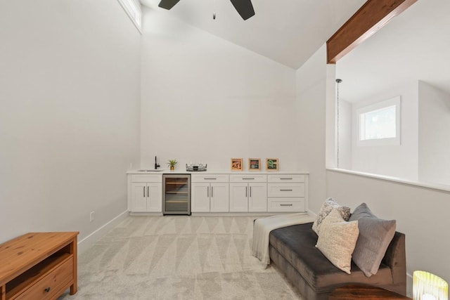 bar with wine cooler, light carpet, indoor wet bar, ceiling fan, and a sink