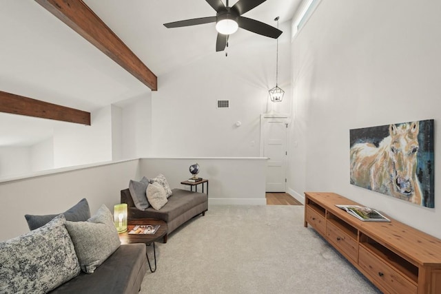 living area with ceiling fan, light colored carpet, beam ceiling, baseboards, and visible vents