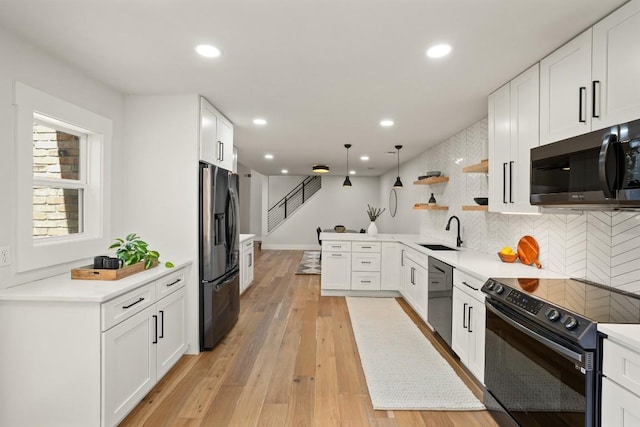 kitchen featuring white cabinets, open shelves, a sink, backsplash, and black appliances