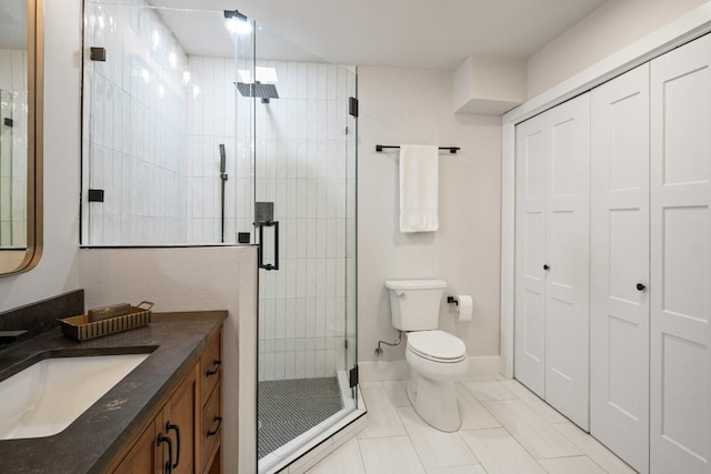 full bath with vanity, toilet, tile patterned floors, and a stall shower