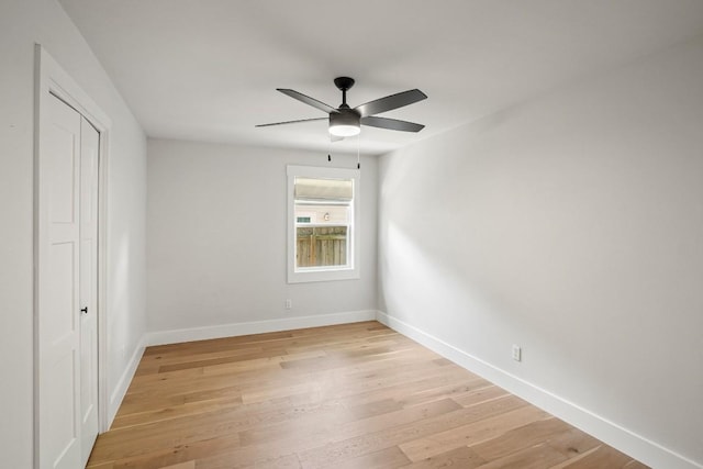 unfurnished bedroom with baseboards, ceiling fan, a closet, and light wood-type flooring
