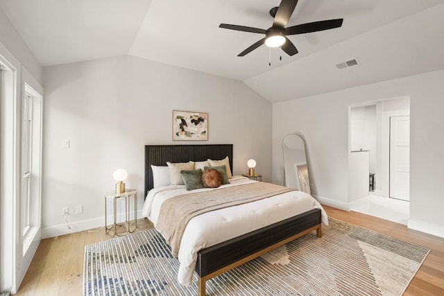 bedroom featuring visible vents, lofted ceiling, baseboards, ceiling fan, and light wood-type flooring