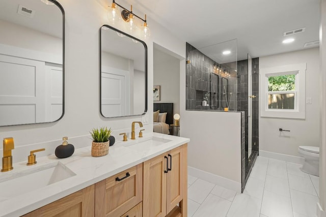 bathroom featuring toilet, visible vents, a sink, and a stall shower