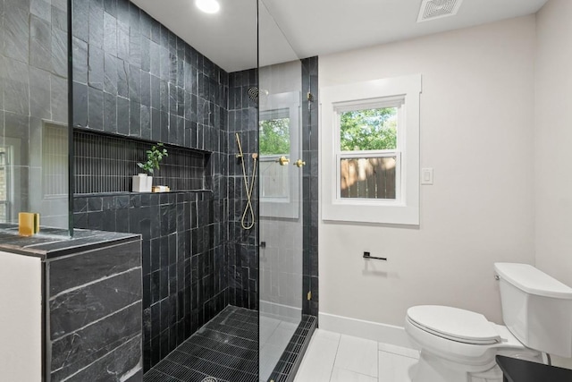 bathroom with visible vents, toilet, baseboards, walk in shower, and tile patterned floors