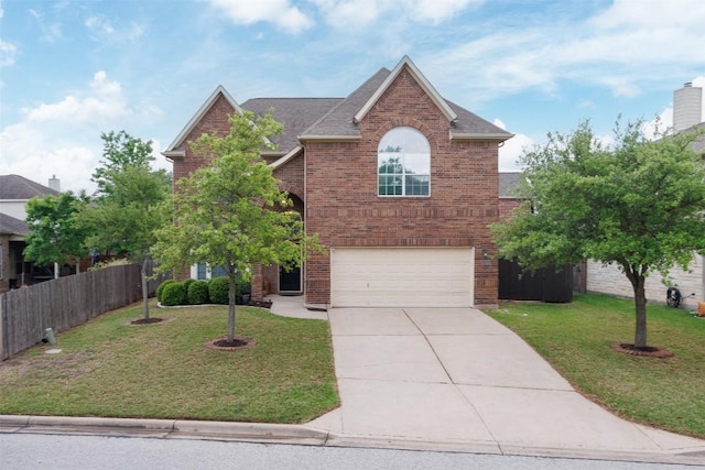 traditional-style house featuring a garage, fence, a front yard, brick siding, and driveway
