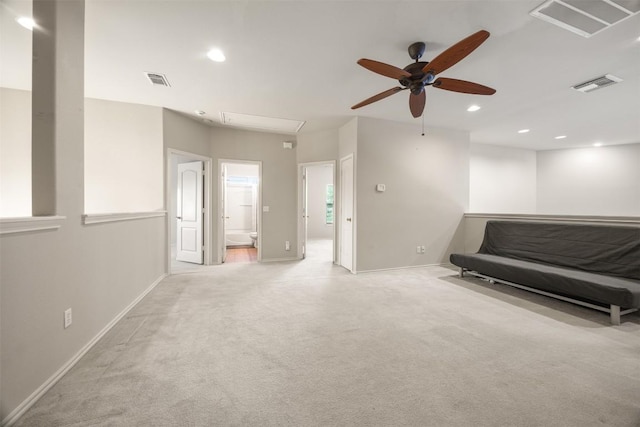 sitting room featuring ceiling fan, attic access, light colored carpet, and visible vents