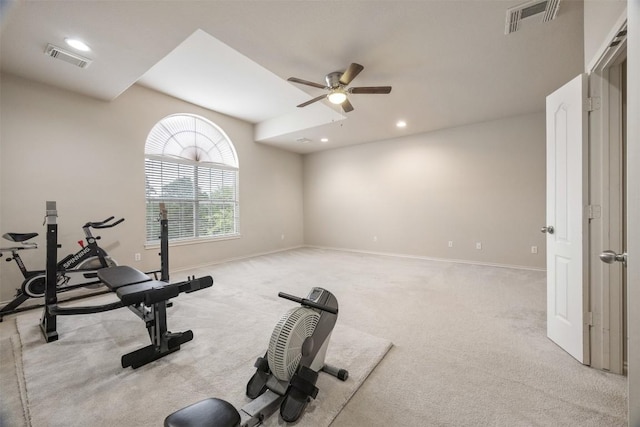 workout room featuring a ceiling fan, light colored carpet, visible vents, and baseboards