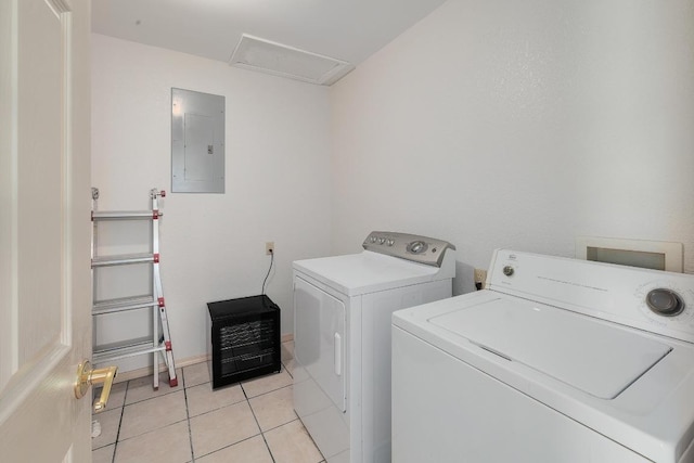 laundry area with laundry area, washer and dryer, light tile patterned floors, and electric panel
