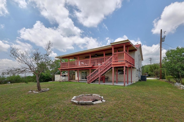 back of house featuring a wooden deck, cooling unit, a patio, stairs, and a yard