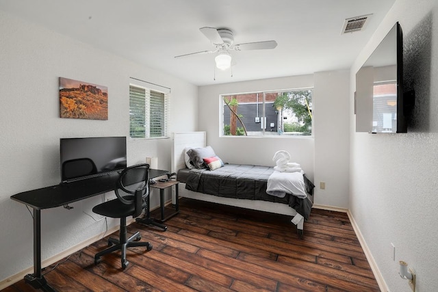 bedroom with a textured wall, ceiling fan, wood-type flooring, baseboards, and visible vents