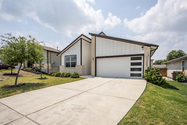 view of front of property featuring board and batten siding, driveway, a front lawn, and a garage