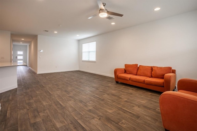 living area featuring dark wood-style flooring, a ceiling fan, visible vents, and recessed lighting