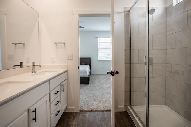full bath featuring a sink, a stall shower, ensuite bath, and wood finished floors