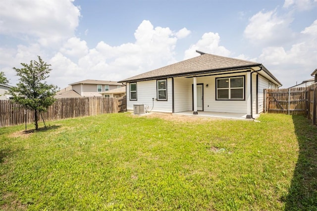 rear view of property featuring a fenced backyard, a lawn, cooling unit, and a patio area