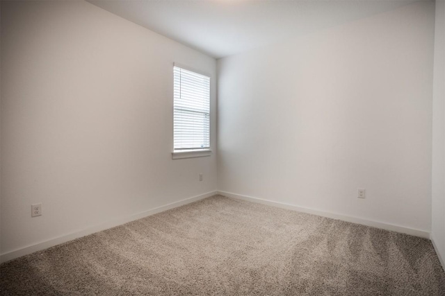 unfurnished room featuring baseboards and carpet flooring