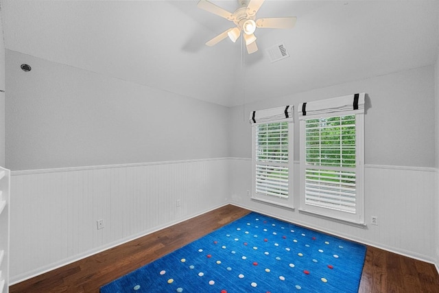 10700 Galsworthy Ln, Austin, TX 78739 - empty room with a wainscoted wall, a ceiling fan, wood finished floors, vaulted ceiling, and visible vents