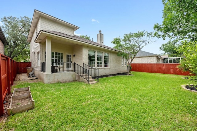 10700 Galsworthy Ln, Austin, TX 78739 - rear view of house featuring a chimney, a garden, a lawn, brick siding, and a fenced backyard