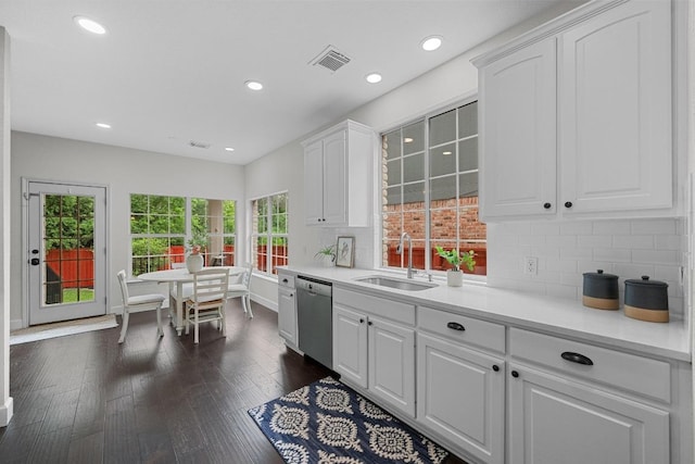 10700 Galsworthy Ln, Austin, TX 78739 - kitchen featuring a sink, dishwasher, light countertops, white cabinetry, and tasteful backsplash