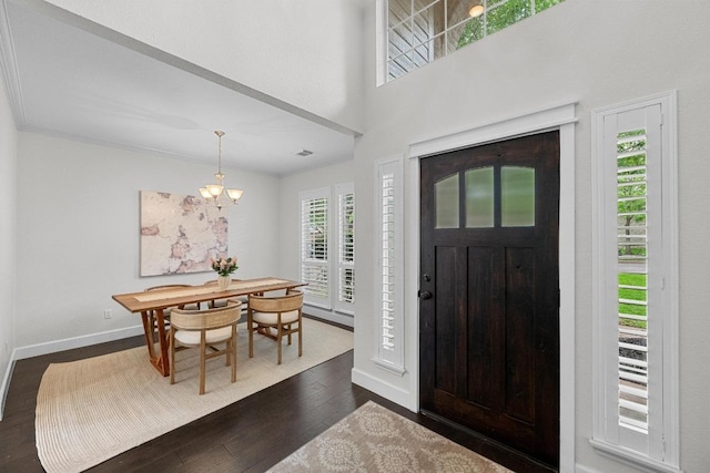 10700 Galsworthy Ln, Austin, TX 78739 - entryway with an inviting chandelier, baseboards, dark wood-style flooring, and visible vents