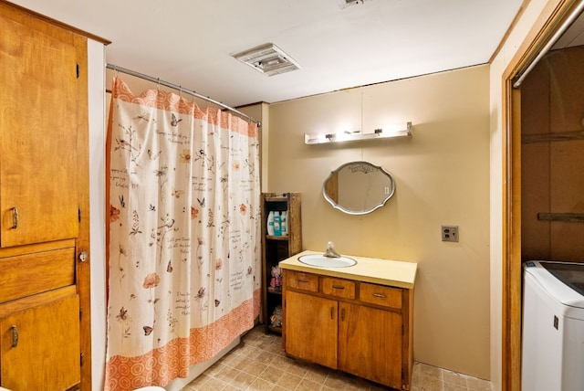 520 Munson St, Tow, TX 78672 - bathroom featuring vanity, washer / dryer, a shower with shower curtain, and visible vents