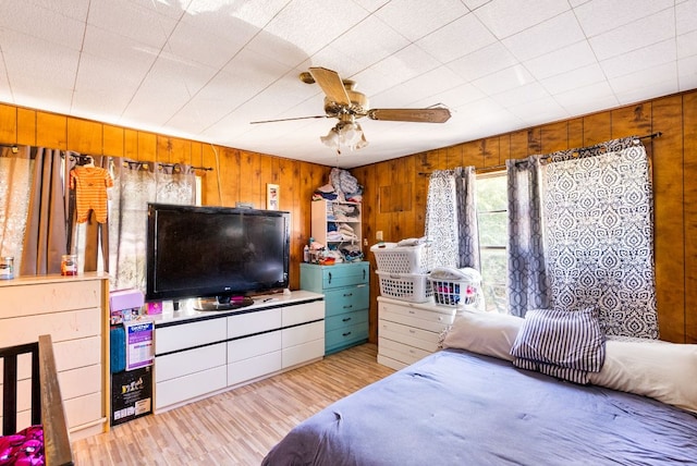 520 Munson St, Tow, TX 78672 - bedroom with wood walls, a ceiling fan, and wood finished floors