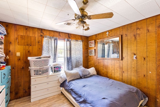 520 Munson St, Tow, TX 78672 - bedroom featuring wooden walls, visible vents, and light wood-style floors