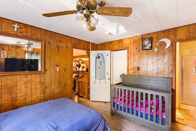 520 Munson St, Tow, TX 78672 - bedroom featuring a ceiling fan, wood walls, and wood finished floors