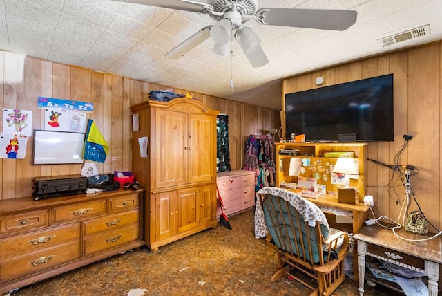 520 Munson St, Tow, TX 78672 - bedroom featuring wooden walls, a ceiling fan, and visible vents