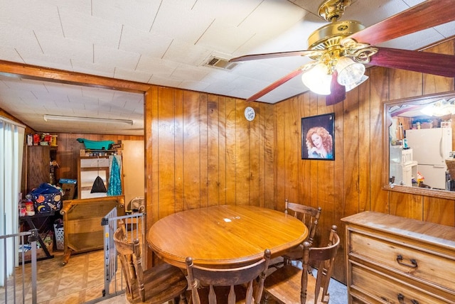 520 Munson St, Tow, TX 78672 - dining room with wooden walls, a ceiling fan, and visible vents