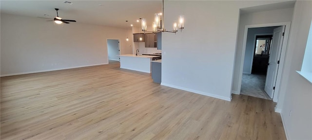 118 Freeman Day Dr, Bastrop, TX 78602 - unfurnished living room with a chandelier, light wood finished floors, and ceiling fan