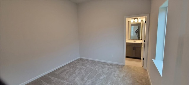 118 Freeman Day Dr, Bastrop, TX 78602 - unfurnished bedroom featuring light carpet, baseboards, and ensuite bathroom