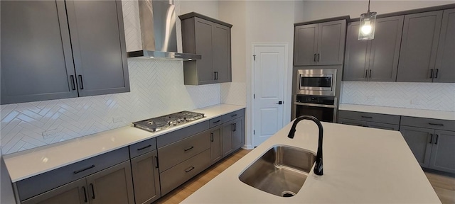 118 Freeman Day Dr, Bastrop, TX 78602 - kitchen with wall chimney exhaust hood, stainless steel appliances, a sink, tasteful backsplash, and pendant lighting