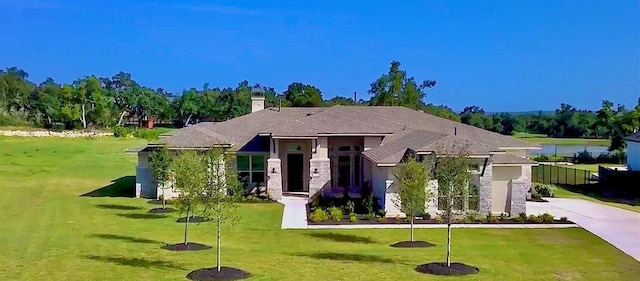 413 Prairie Clover Dr, Dripping Springs, TX 78620 - view of front of home with an attached garage, a chimney, driveway, and a front yard