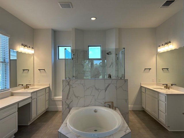 413 Prairie Clover Dr, Dripping Springs, TX 78620 - bathroom featuring a marble finish shower, two vanities, a bath, and visible vents