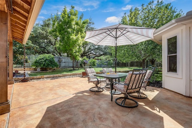 view of patio with outdoor dining area and a fenced backyard