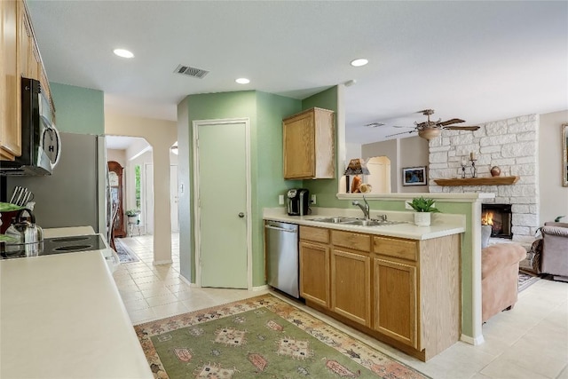 kitchen featuring ceiling fan, appliances with stainless steel finishes, a sink, open floor plan, and visible vents