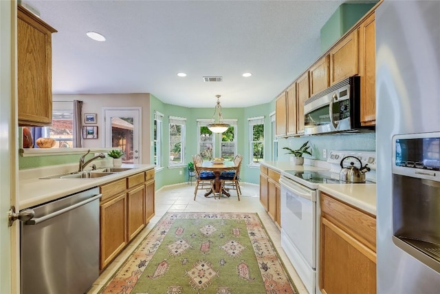 kitchen with visible vents, recessed lighting, light countertops, a sink, and stainless steel appliances