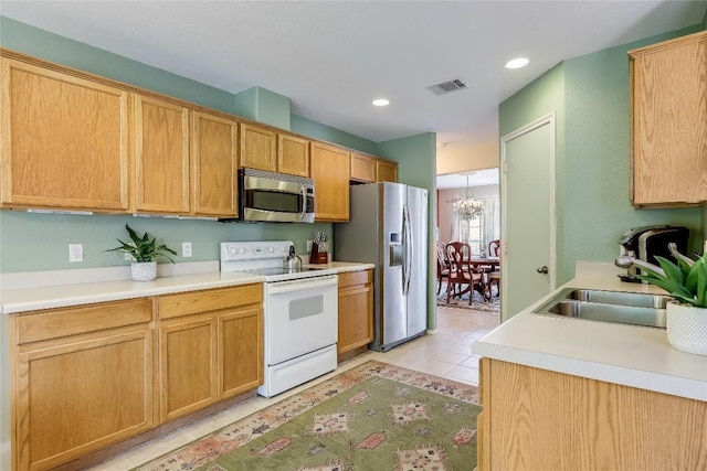 20603 Camel Back St, Lago Vista, TX 78645 - kitchen featuring appliances with stainless steel finishes, a sink, light countertops, and recessed lighting