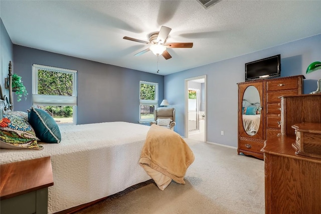 20603 Camel Back St, Lago Vista, TX 78645 - carpeted bedroom featuring ensuite bathroom, a ceiling fan, and baseboards