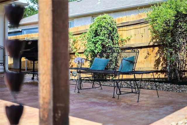 view of patio / terrace featuring fence