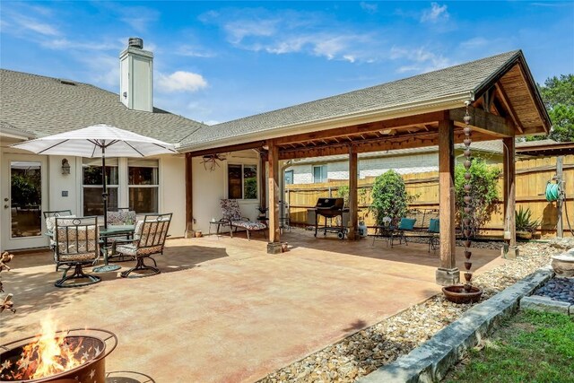 20603 Camel Back St, Lago Vista, TX 78645 - view of patio / terrace with an outdoor fire pit, ceiling fan, and outdoor dining space