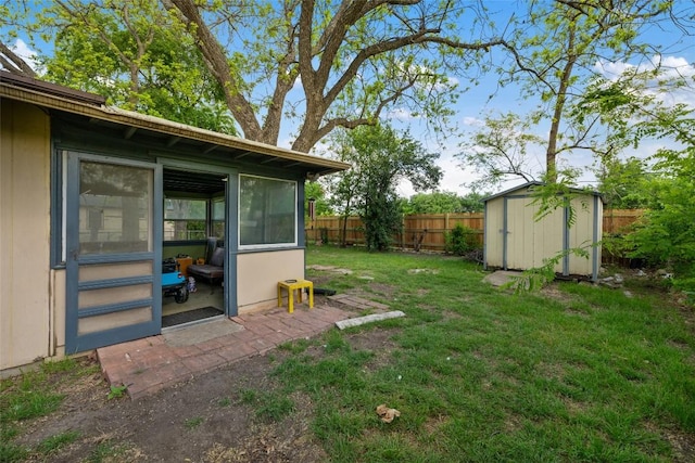 view of yard featuring an outdoor structure, a shed, and a fenced backyard