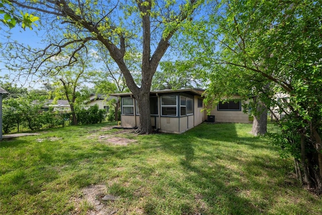 view of yard with fence and a sunroom