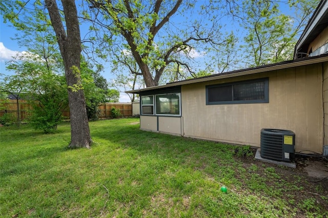 view of yard with fence and cooling unit