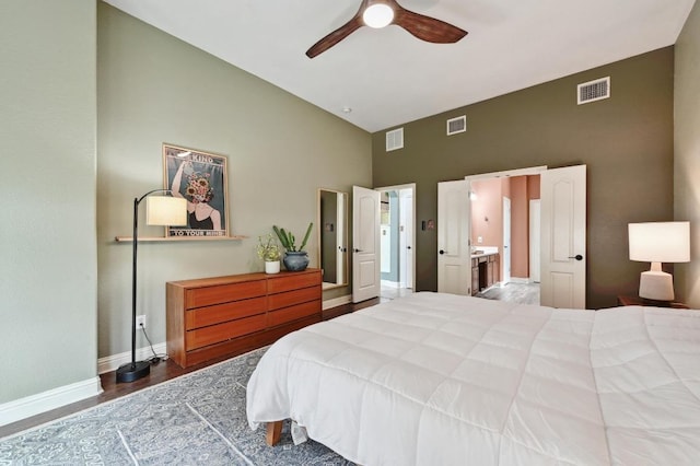bedroom with visible vents, baseboards, and high vaulted ceiling